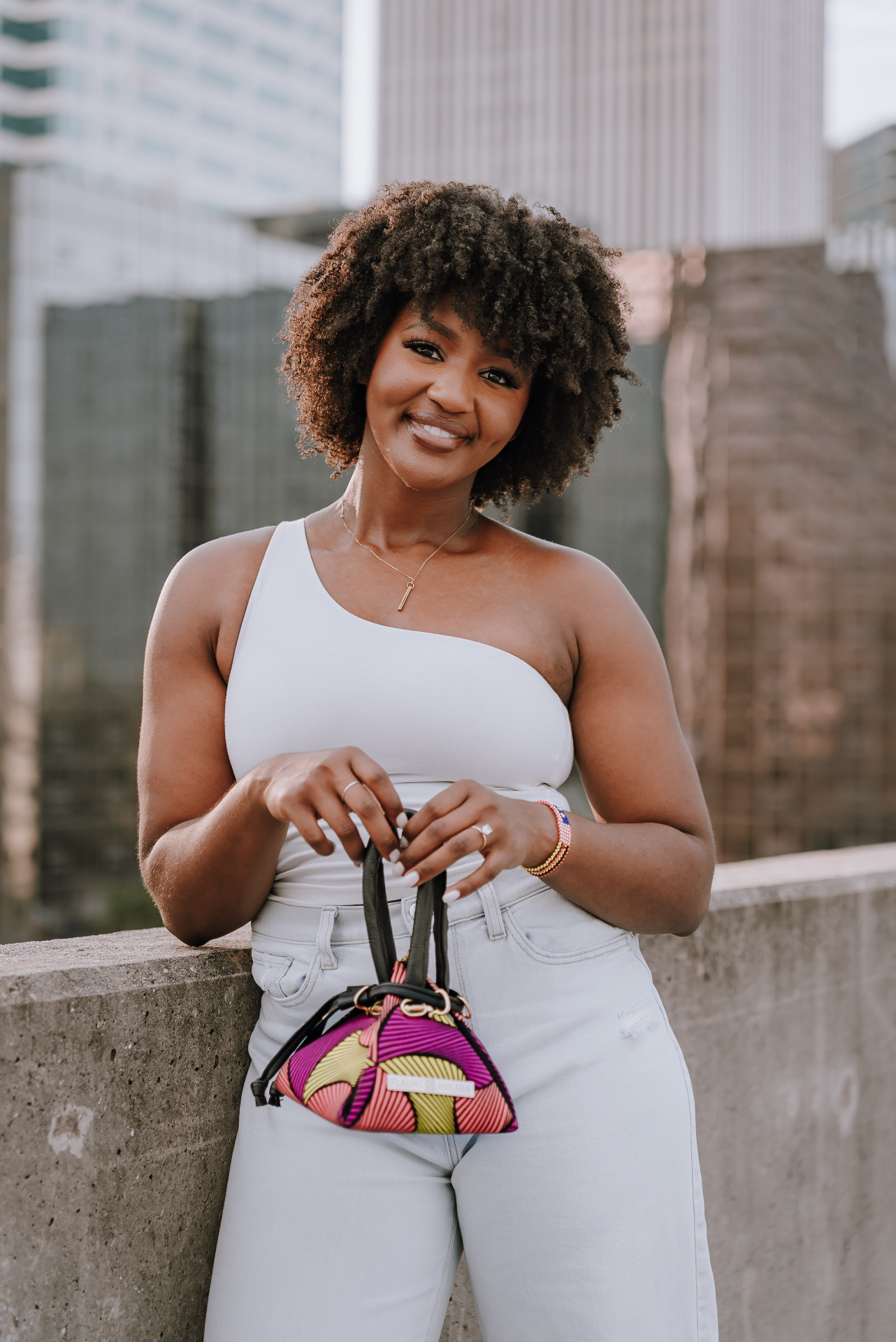 A Black woman with natural curly hair, warm editorial portrait